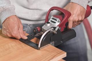 Lamello Classic X biscuit joiner in use, cutting a slot in a wood panel
