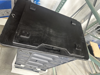 Underside of the custom black top plate that the Tormek mounts to, showing the 3D-printed alignment feet