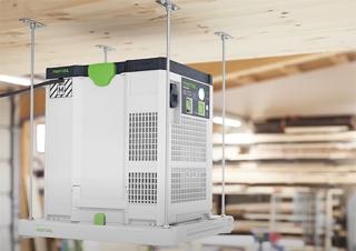 Festool SYS-AIR suspended from a workshop ceiling on four threaded rods using the DH-SYS-AIR mounting kit, with a lumber rack visible behind