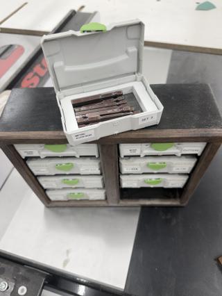 An open Systainer³ XXS labeled METRIC ALLEN HEAD SET 2 holding six hex bits in a cut foam insert, sitting on top of a dark shop-made wooden cabinet that holds seven more labeled cases
