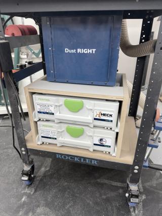 Two Systainer³ M 137 cases seated in a shop-made plywood cabinet under a Rockler router table, with a Dust Right collector sitting on top of the cabinet