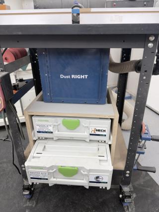 The lower Systainer³ M 137 pulled halfway out of the plywood cabinet on its rails, showing how the case slides like a drawer under the router table