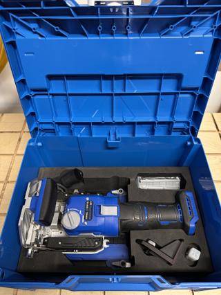 A sky blue Systainer³ M 237 open on a tiled floor, the Kreg Edge loose tenon joiner lying in Kreg's black foam insert with its stabilizer base, a bag of tenons and a cutter in their own pockets